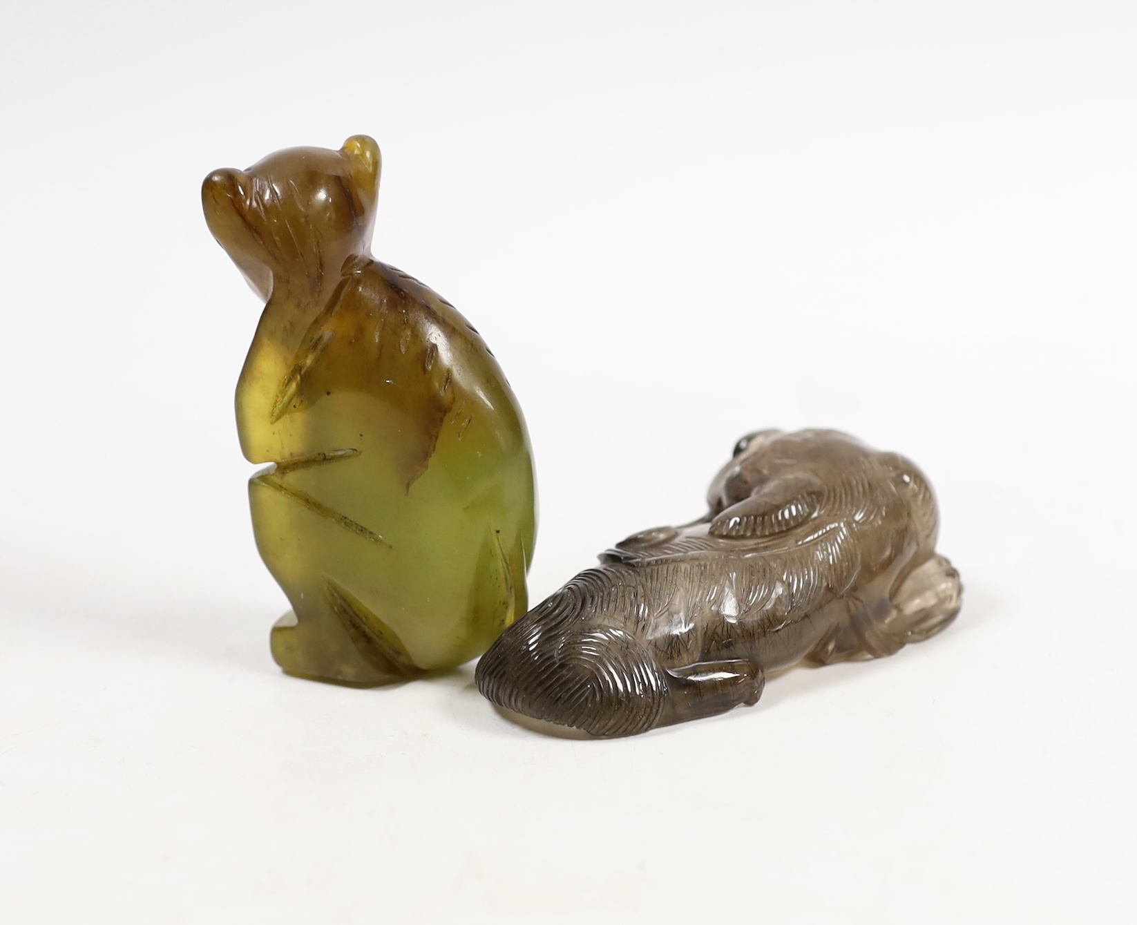 A Chinese smokey quartz lion scent bottle and a carved bowenite model of a monkey, longest 7.5cm